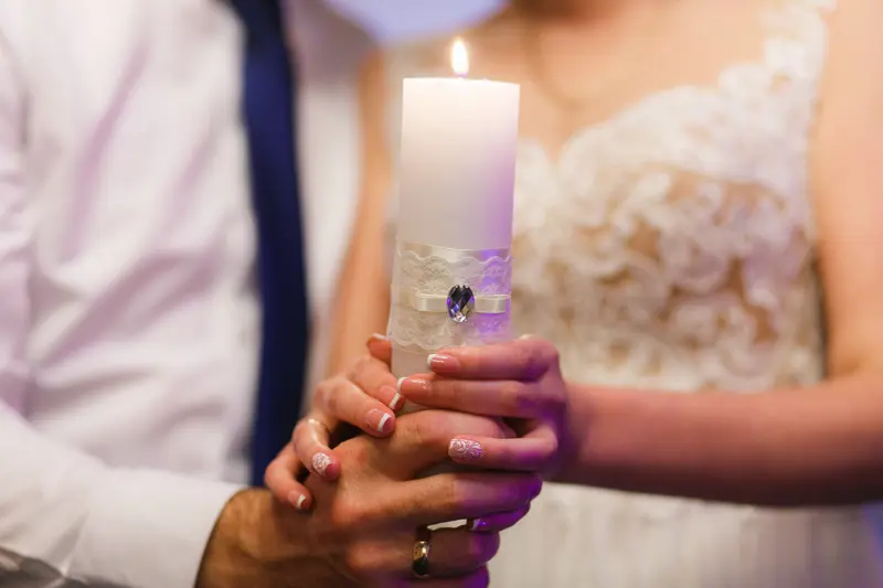 Wedding couple holding a candle